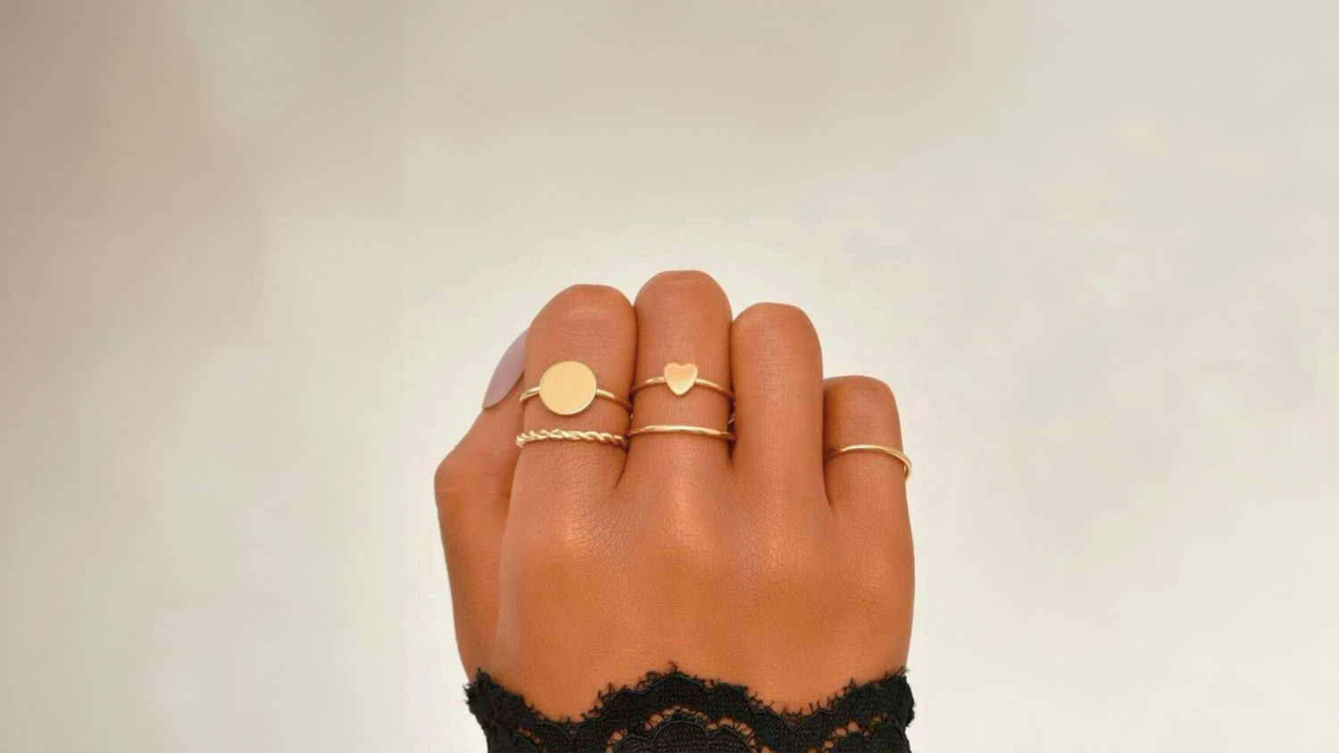 cover page for outlet collection showing the minimalist ring being worn with other rings