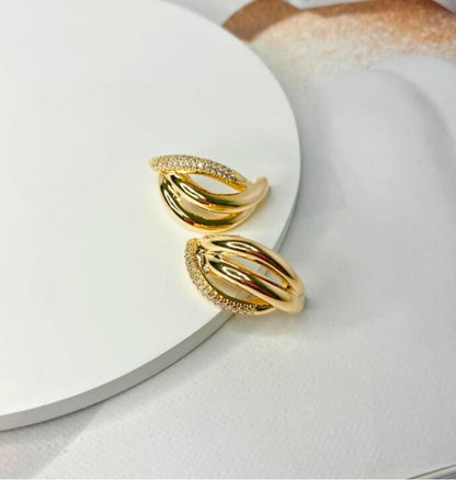 Close-up view of elegant Elo earrings featuring an 18K gold-plated finish with cubic zirconia accents, showcasing their sleek and sophisticated design.